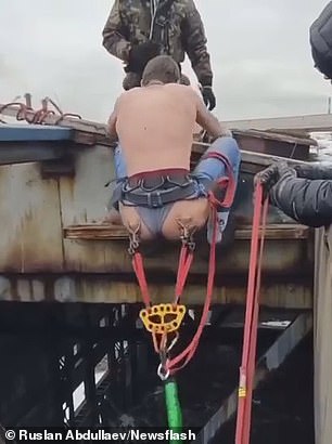 Bumgee jump! Russian daredevil bungee jumps off an abandoned warehouse with cord attached to buttock piercings