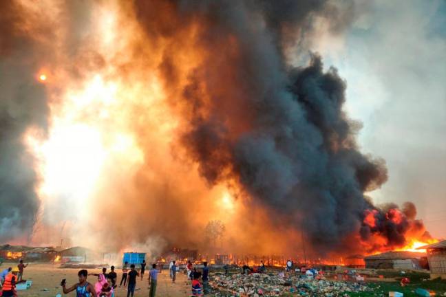 Tens of thousands flee huge blaze in Rohingya camp in Bangladesh