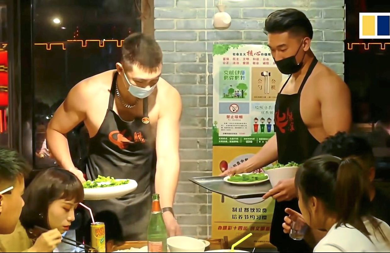 Shirtless waiters deliver good service at hotpot restaurant in China