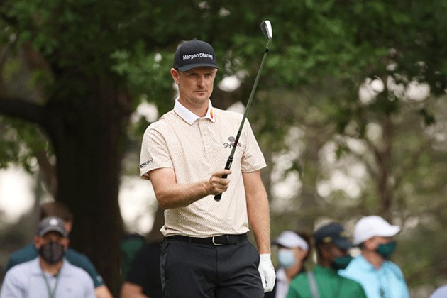 Justin Rose clings to slim lead as storm halts Masters