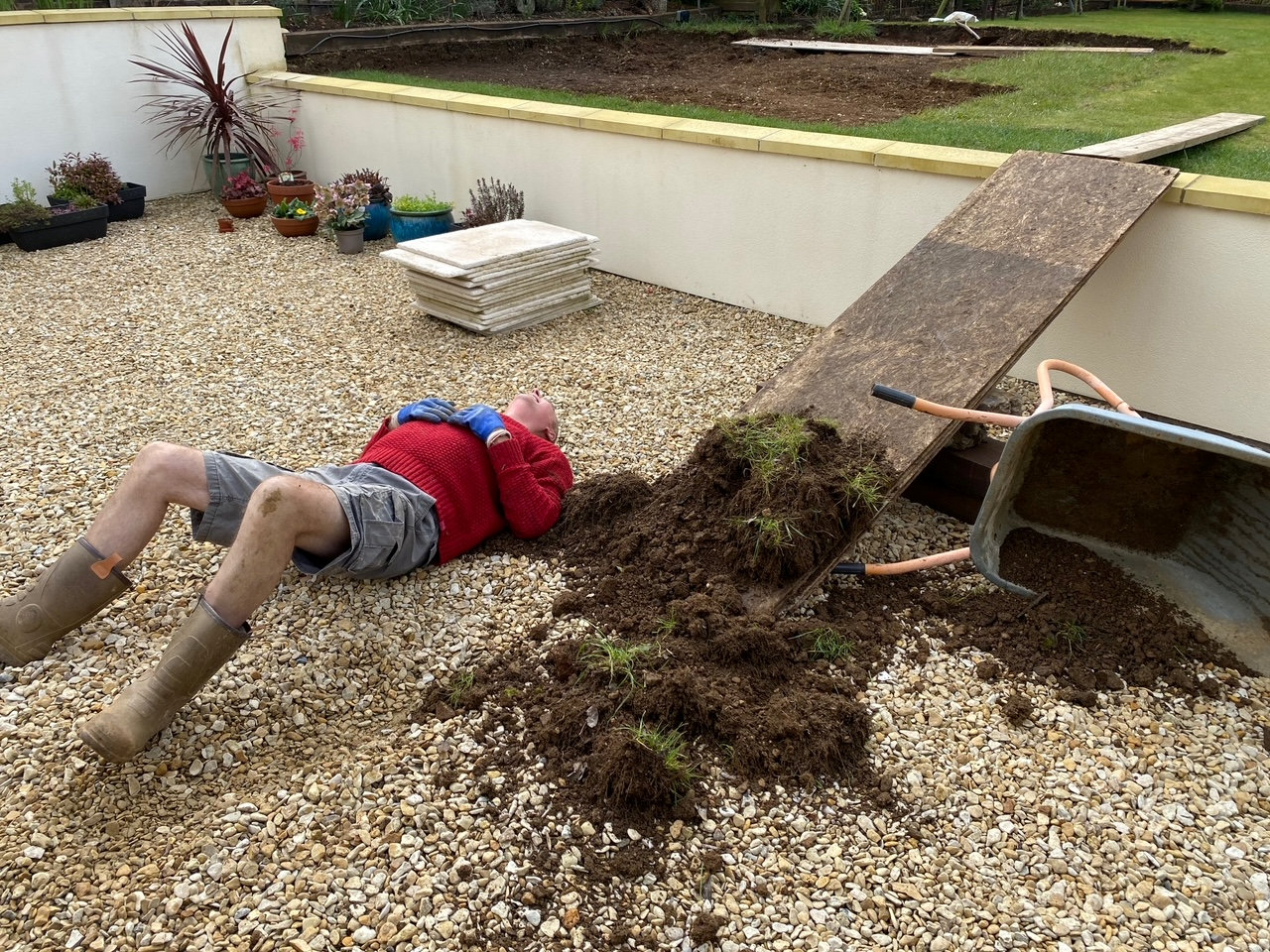 Man Drops Entire Wheelbarrow Of Soil Over Himself After Falling Off Ramp