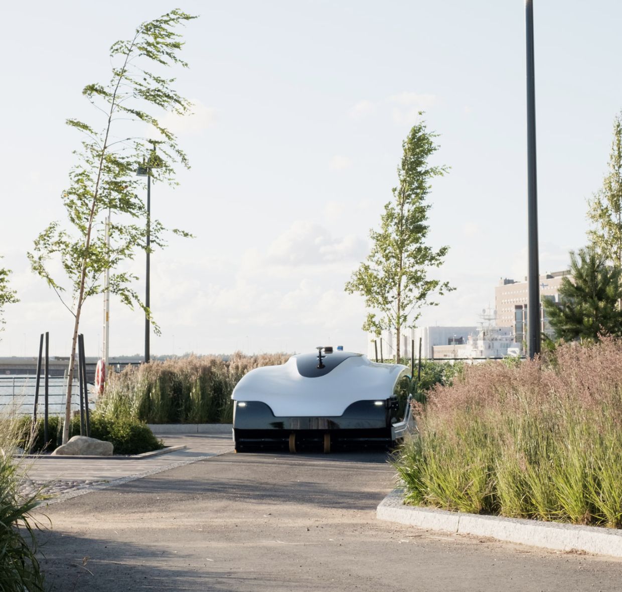 The electric, autonomous street sweeper cleaning Helsinki by night