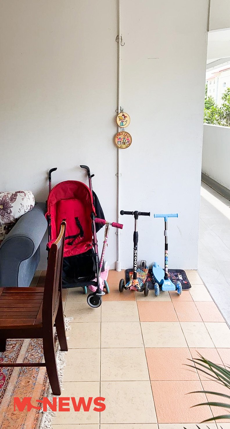 HDB lift lobby turns into extended living room, includes office corner, table & couch