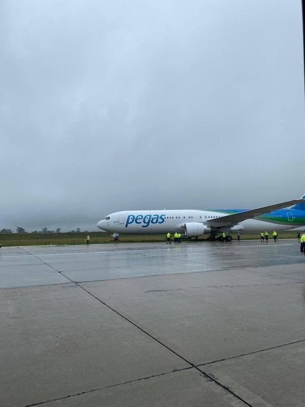 Boeing 737 passenger plane rolls off runway and blocks landing strip at airport
