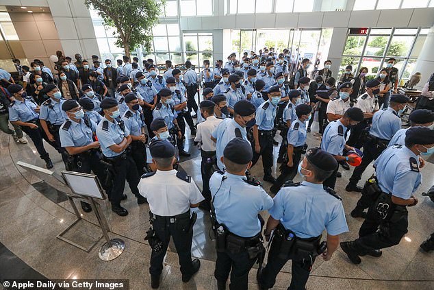 Hong Kong citizens queue up to buy pro-democracy Apple Daily in support of press freedom a day after police raided its offices and arrested senior staff under national security laws