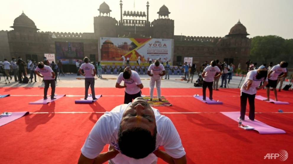 Free COVID-19 vaccines for all Indian adults as Modi hails yoga 'shield'