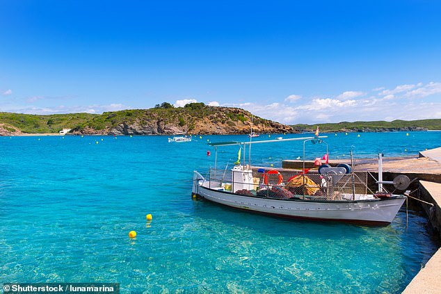British tourist, 79, dies 'in front of his wife and son' after slipping and hitting his head on rocks as he came out of the sea in Menorca