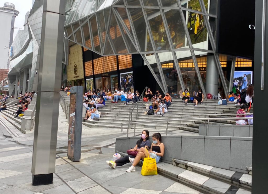 Maids having picnic party at orchard, some in groups of 7