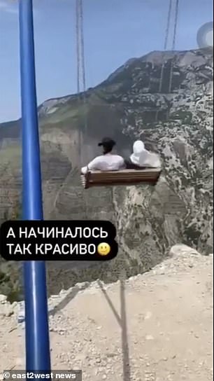 Terrifying moment two women fall off a swing on the edge of a 6,300ft precipice in Russia... and are only saved by narrow platform below