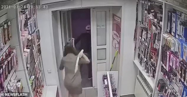 'Armed robber' is beaten up with a sex toy: Cashier grabs 18-inch 'weapon' and bashes knife-wielding 'thief' at Russian sex shop