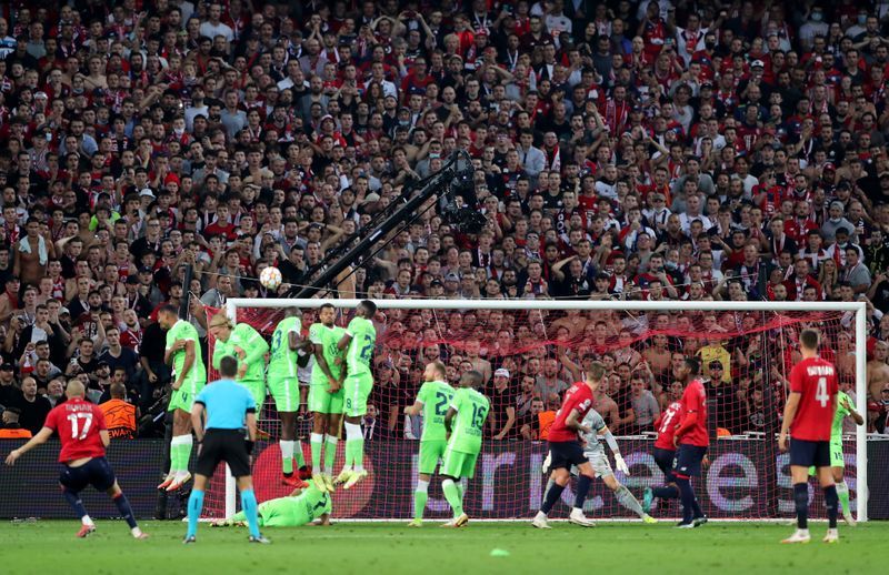 Soccer-Lille held by 10-man Wolfsburg in Champions League opener