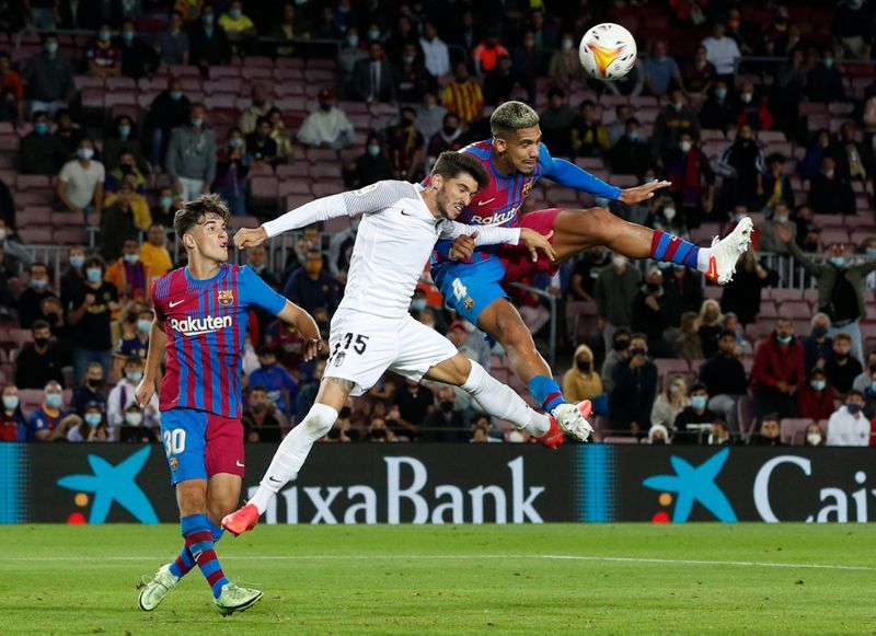 Soccer-Barca scrape late draw with Granada as fans stay away