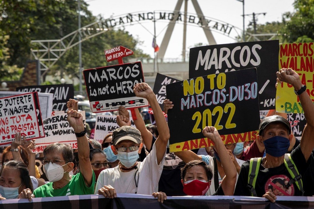 Filipino protesters carry ‘Marcos is no hero’ and ‘never again’ banners to mark late dictator’s burial anniversary