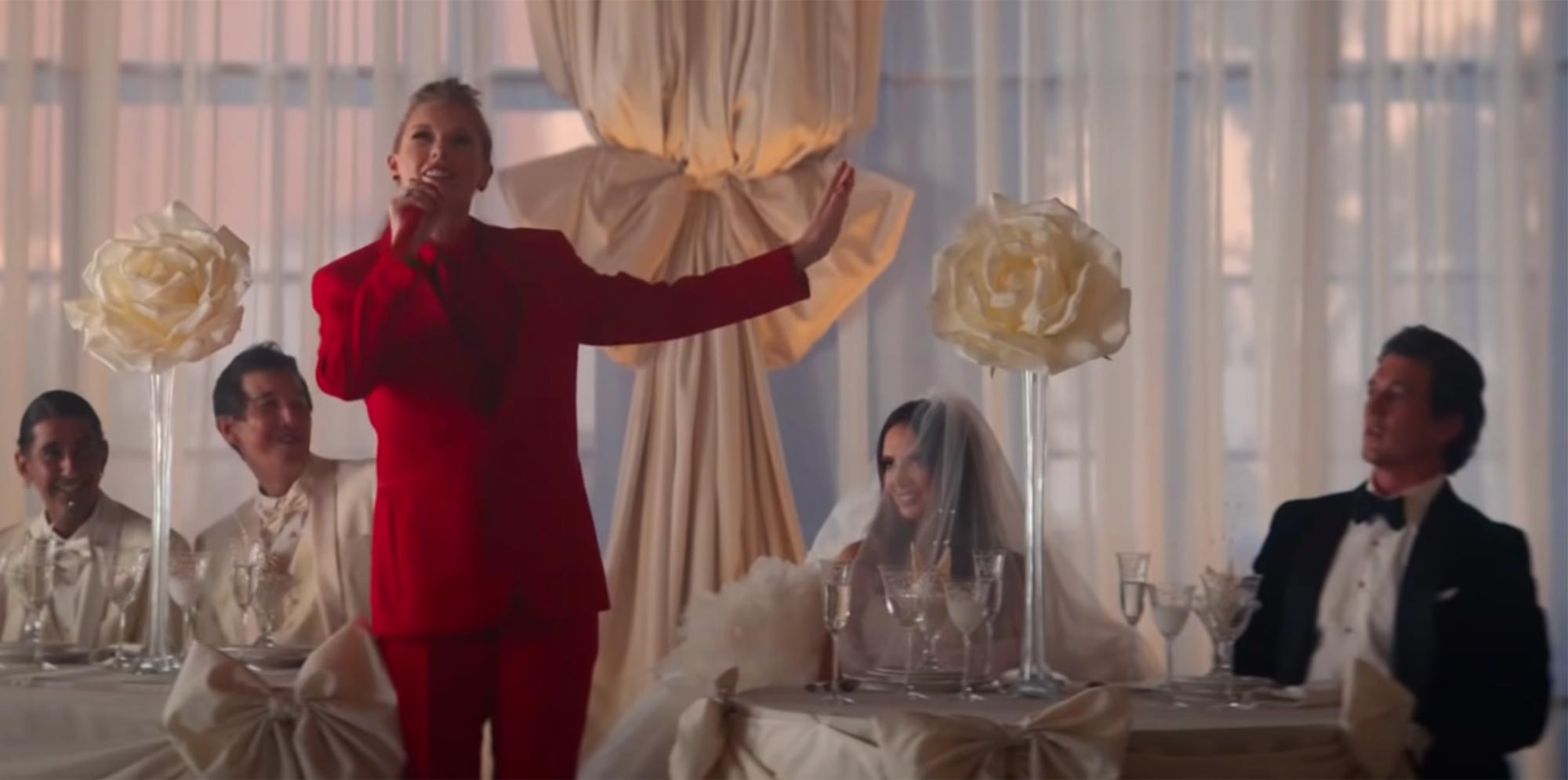 Taylor Swift crashes Miles Teller and his real-life wife's wedding in 'I Bet You Think About Me' music video