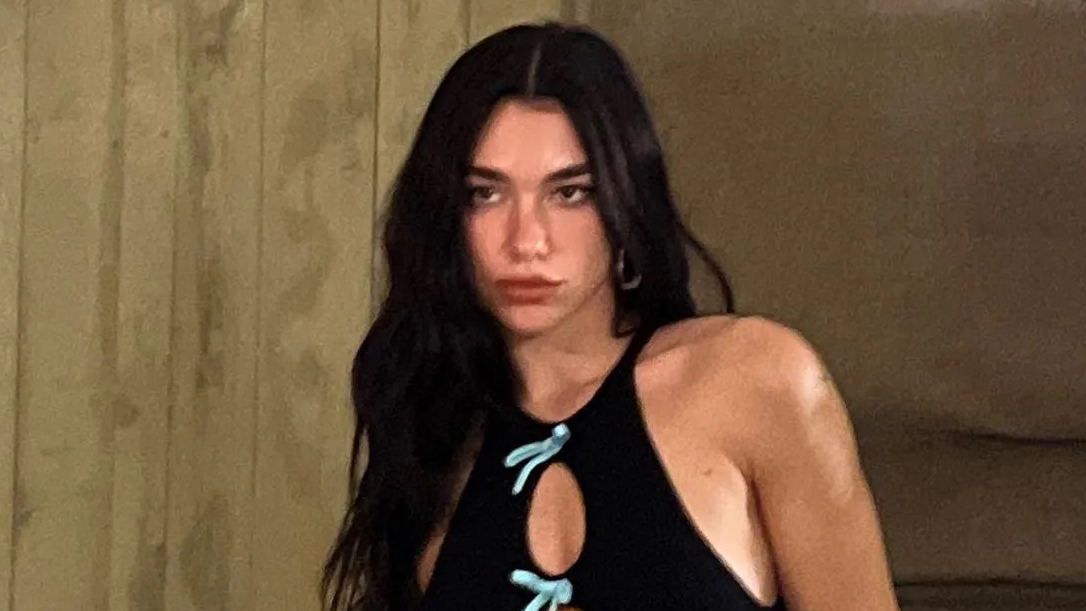 Dua Lipa Posed in a Bathtub Wearing a Plunging Cutout Jumpsuit and the Sparkliest Stilettos