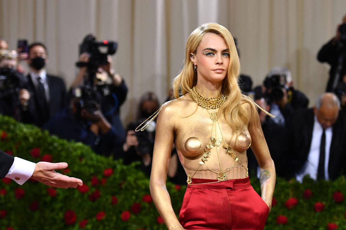 Cara Delevingne displays gold-painted breasts at Met Gala