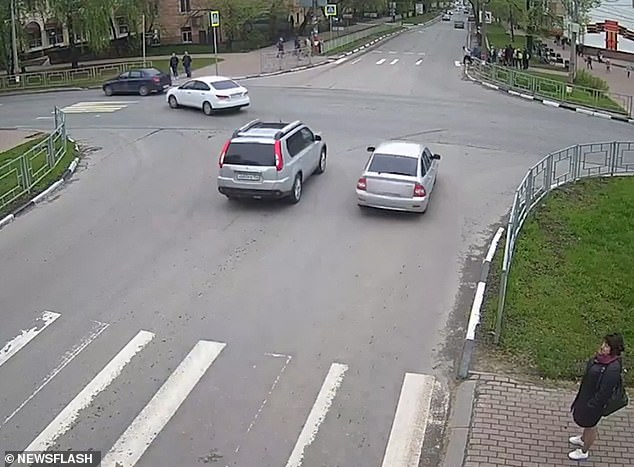 Horrifying moment four children are injured when Russian teenage driver jumps a red light and smashes into them on a pedestrian crossing