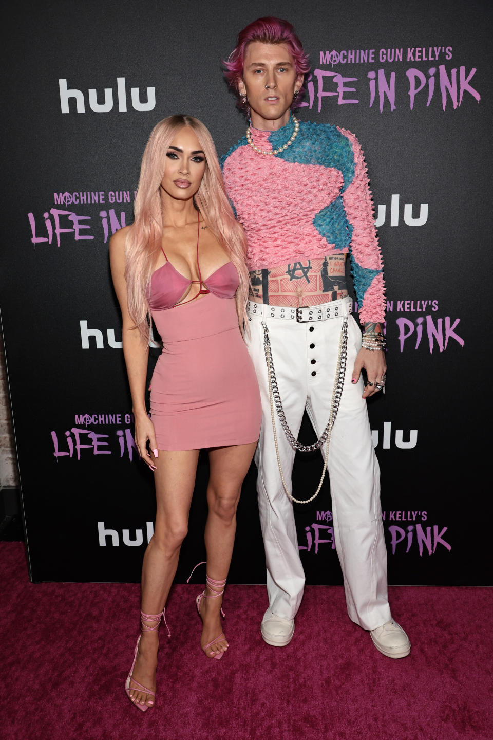 Megan Fox and fiancé Machine Gun Kelly debut pink hair at premiere