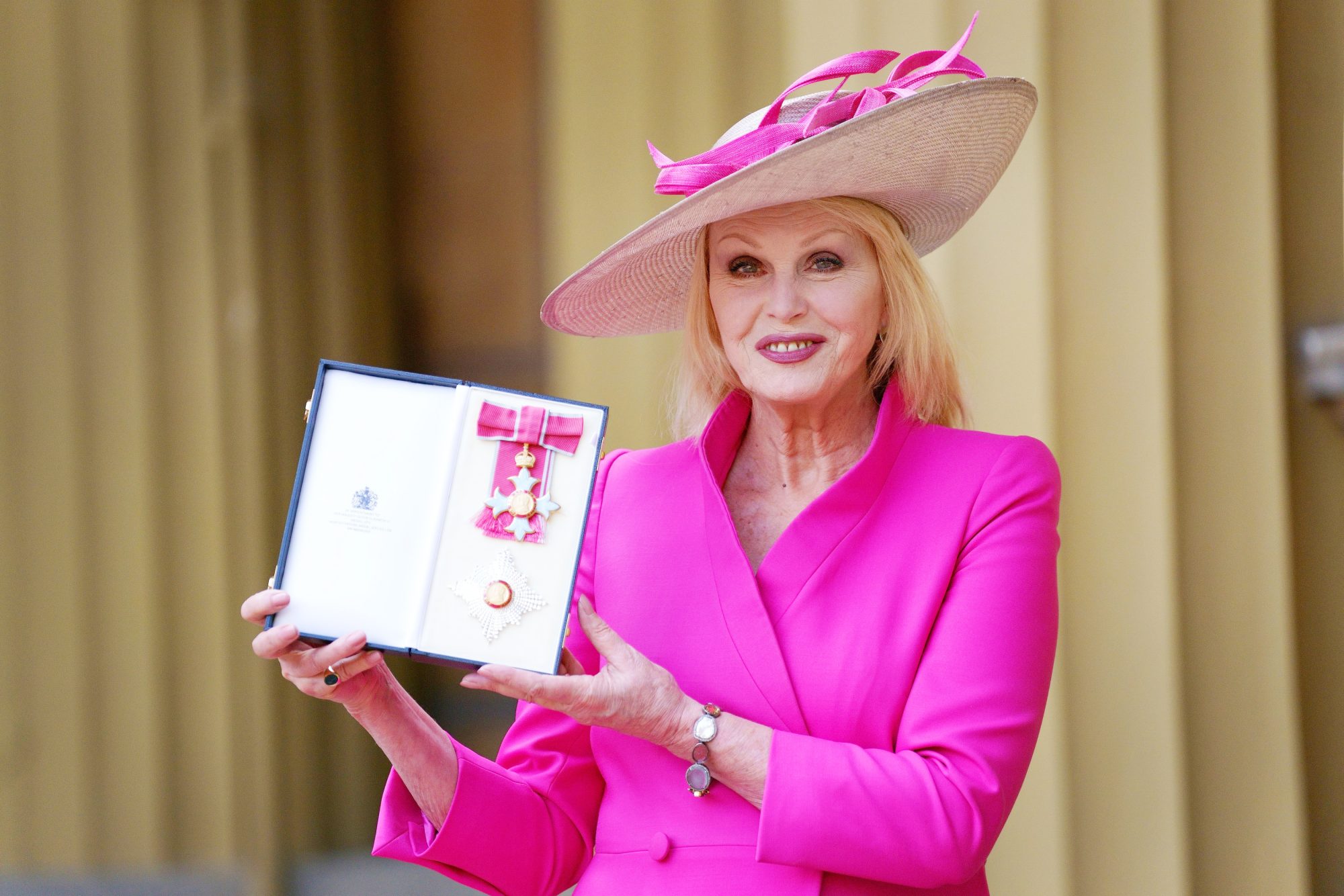 Joanna Lumley Matches Her Hot Pink Outfit to Her Damehood Medal in Ceremony with Princess Anne