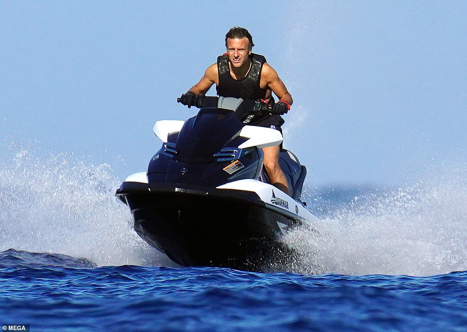 Macron sails into hot water: President is branded an eco-hypocrite for roaring around French Riviera on a gas-guzzling jet-ski after telling citizens to save energy