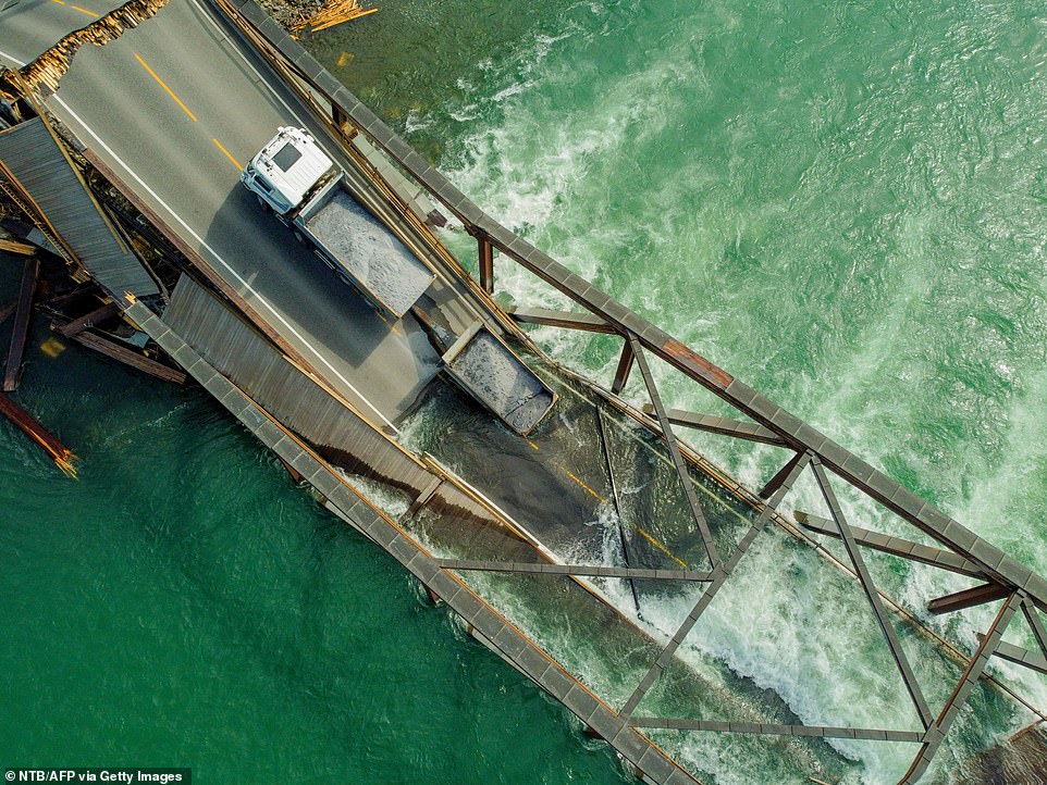 Huge 485ft wood and steel bridge crashes down into Norwegian river just ten years after opening with drivers somehow surviving the 'catastrophic' collapse as they crossed