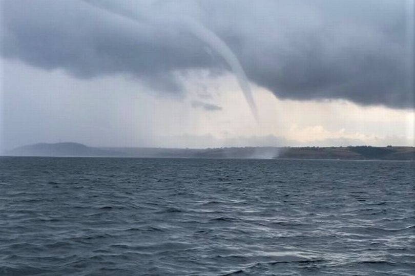 Giant waterspout emerges from sea as UK is hit with thunderstorms and ...