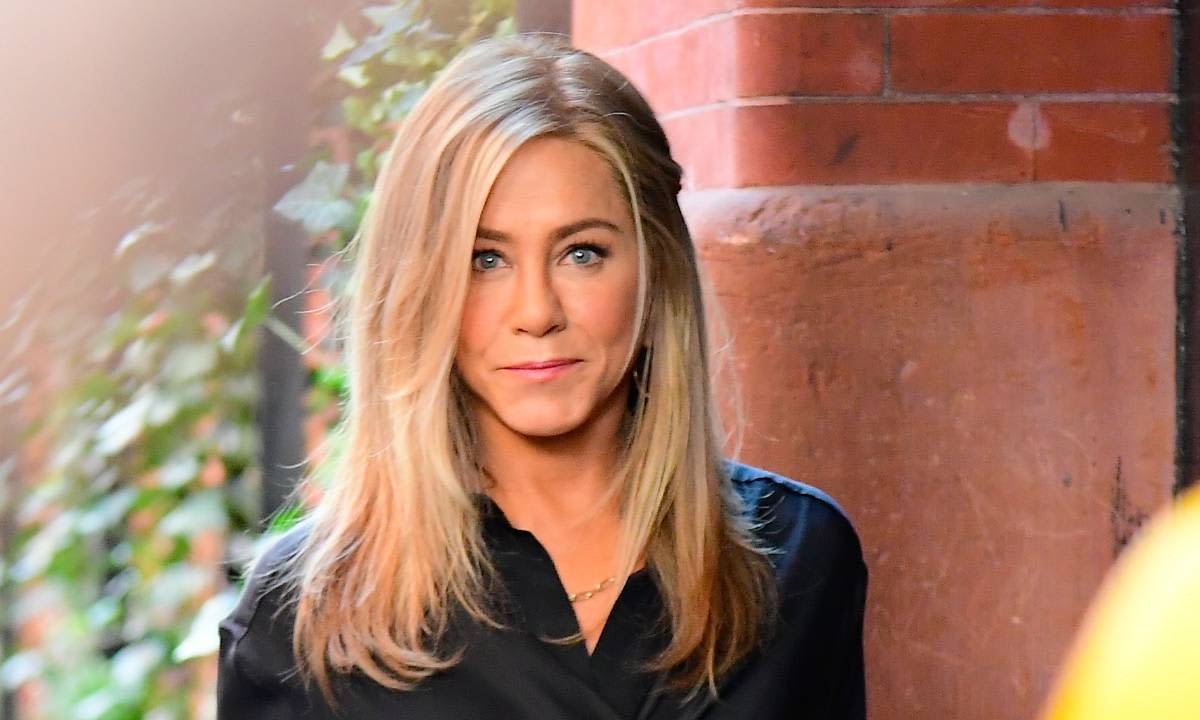 Jennifer Aniston looks chic as ever hopping in a vintage car alongside Jon Hamm in New York City