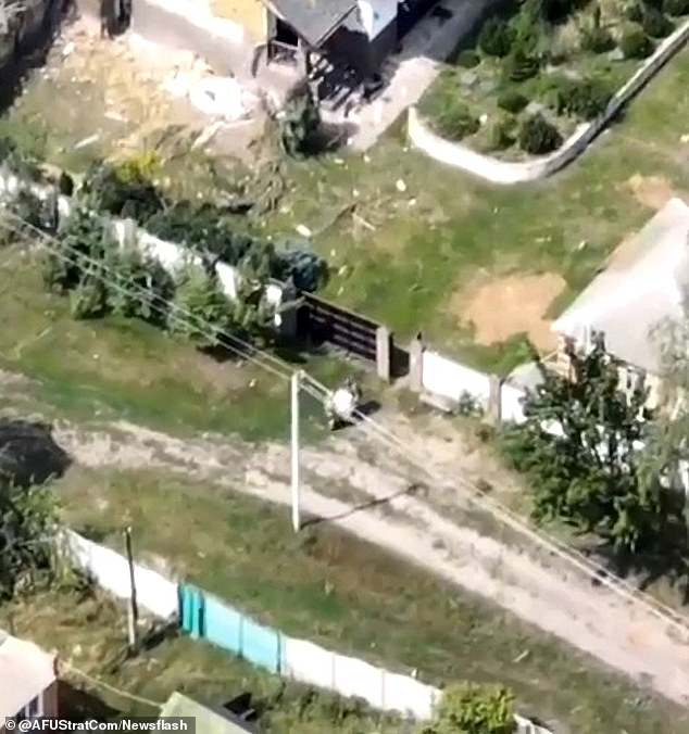 Now Russia 'liberates'... a WASHING MACHINE: Putin's men are spotted stealing kitchen appliance from Ukrainian home