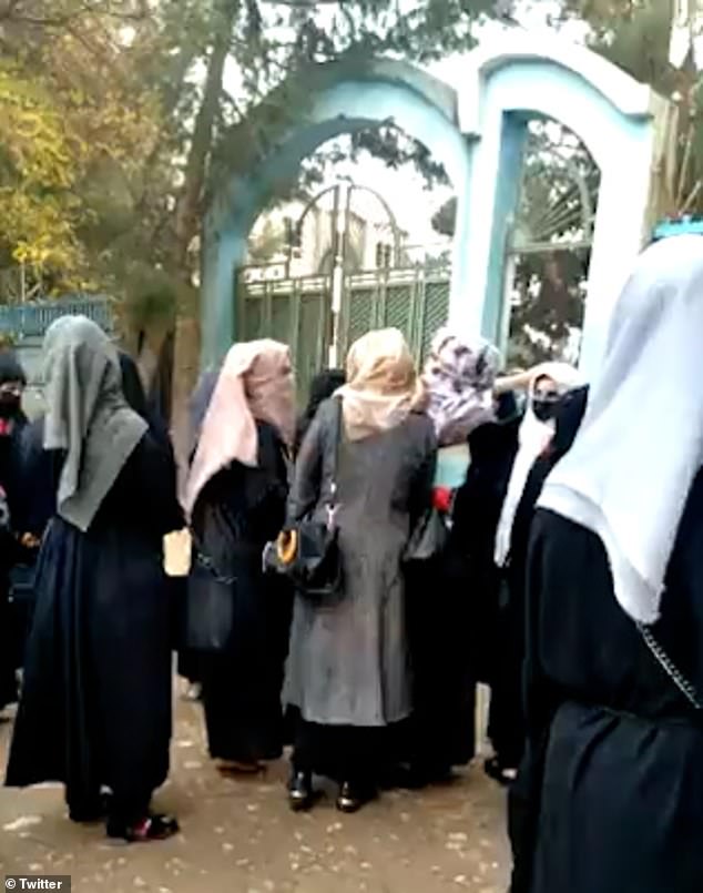 Shocking moment Taliban thug WHIPS female students outside Afghanistan university: Ministry of Virtue official lashes out at women in hijabs for not wearing full body-covering burkas