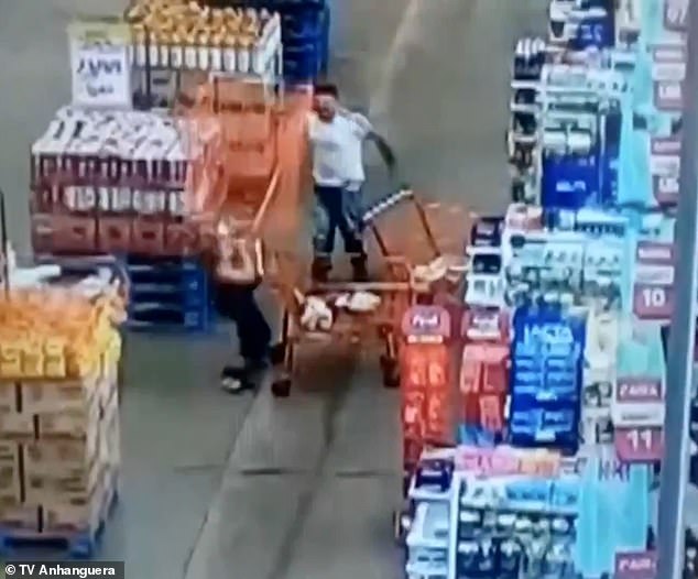 Knockout at the checkout: Man throws a SHOPPING TROLLEY at female customer, smashing her unconscious after they argued while queuing at Brazil store