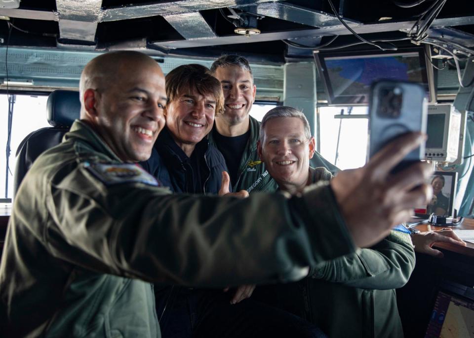 Tom Cruise snaps selfies with crew aboard US Navy aircraft carrier for special screening of Top Gun: Maverick