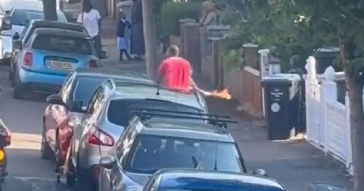 Moment man charges down street with Molotov cocktail as residents scream