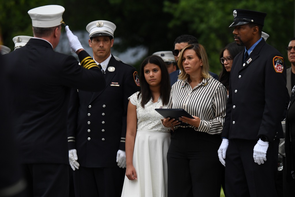 Gut-wrenching photos show widow at funeral of NYC firefighter who drowned saving daughter