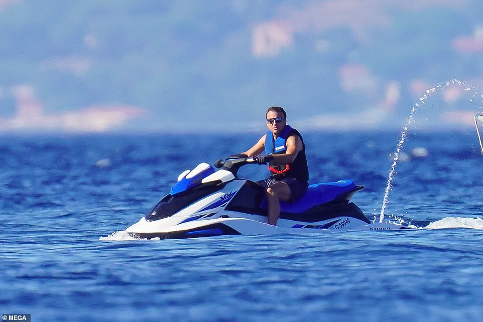 Je t'aime! Emmanuel Macron and wife Brigitte look the picture of love during holiday in France as the president shows off his physique and enjoys some snorkelling and jet-ski riding