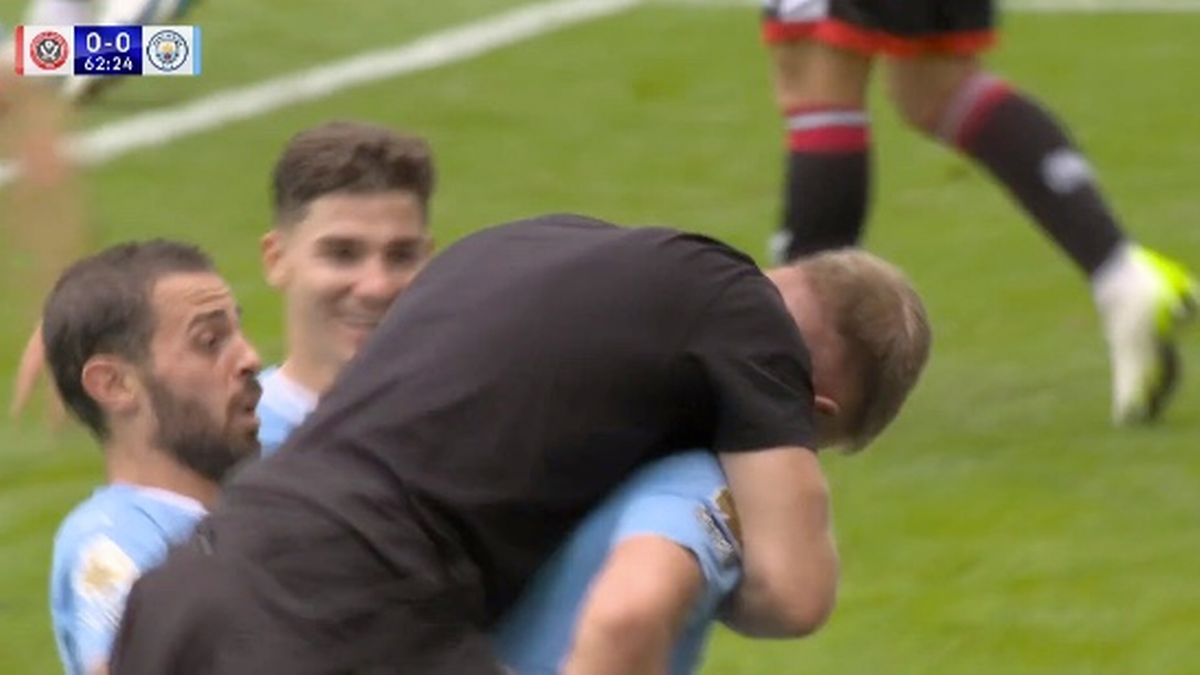 Man City pitch invader tackled by security after jumping on Erling Haaland