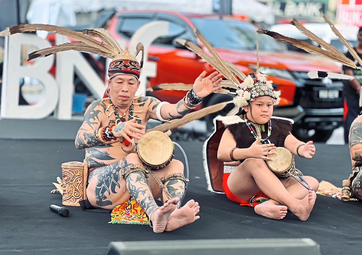 Playing the gendang pampat to help promote Sarawak's traditional music