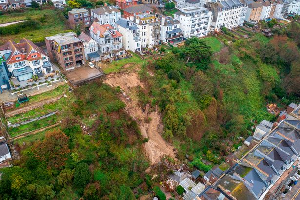 Terrifying aerial images show huge landslip hitting coastal town as locals are evacuated