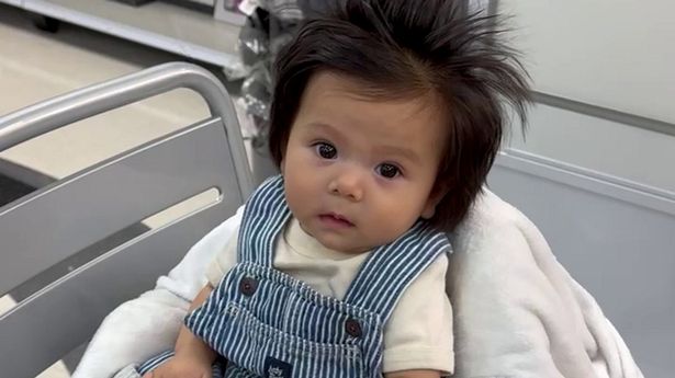 'My baby's hair is so thick people think it's a wig - she's only five-months-old'