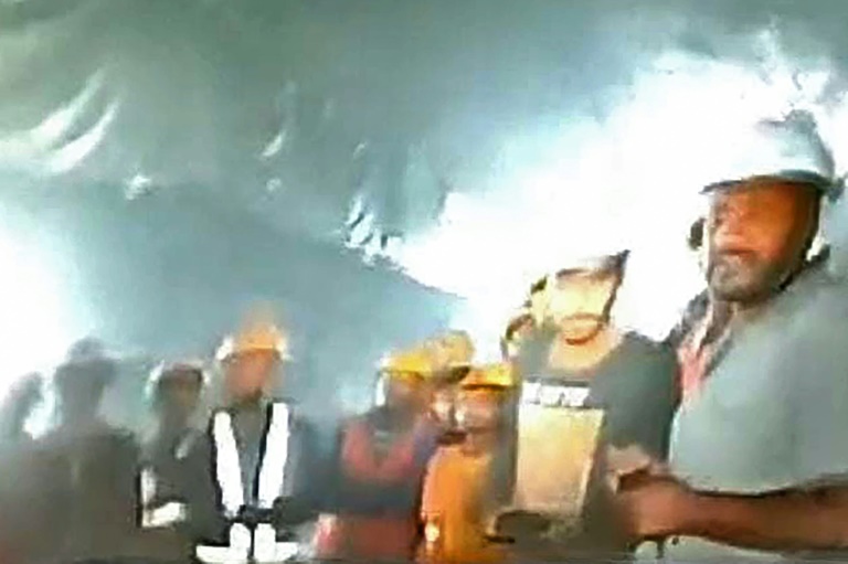 Families of Indian workers trapped in tunnel pray for rescue