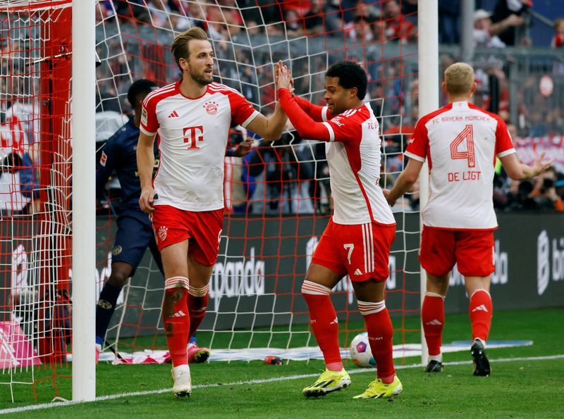 Soccer-Record-breaking Kane nets hat-trick as Bayern humble Mainz 8-1