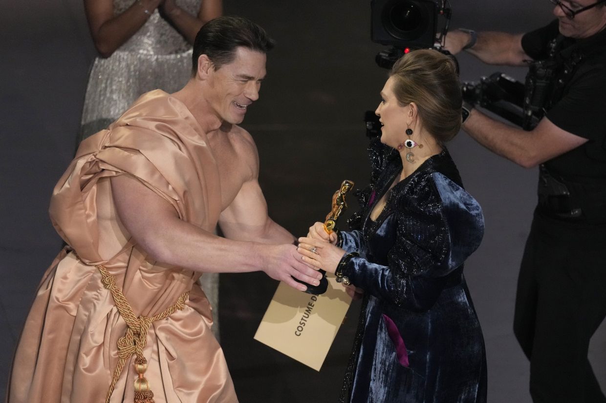 Actor John Cena appears nude on stage at the Oscars