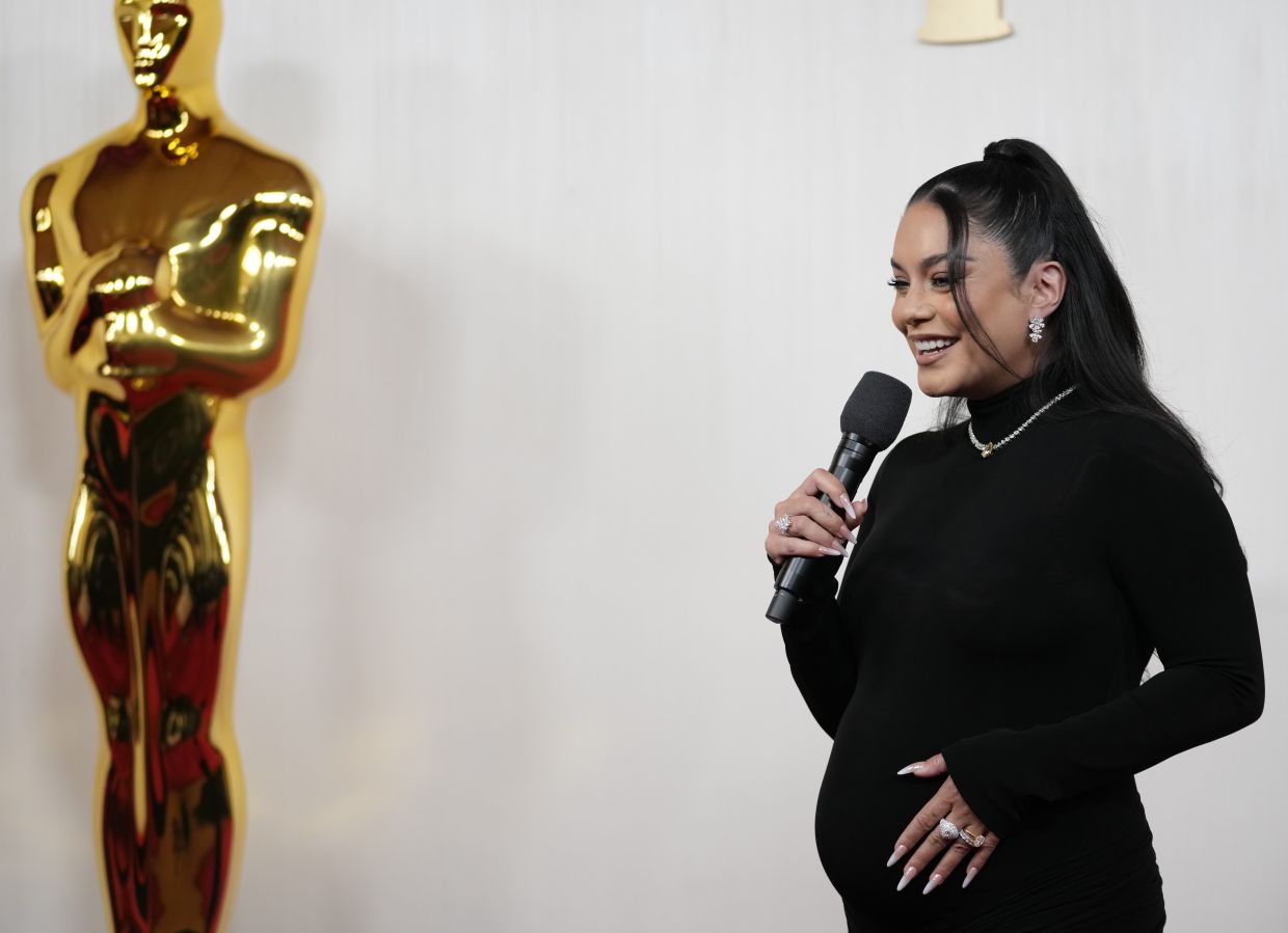 Vanessa Hudgens debuts baby bump on Oscars 2024 red carpet