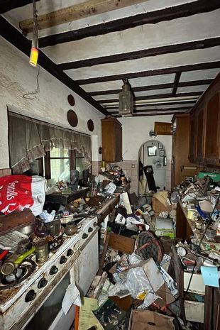 Inside 'most packed hoarder's home of all time' filled with stuffed birds and rotten food