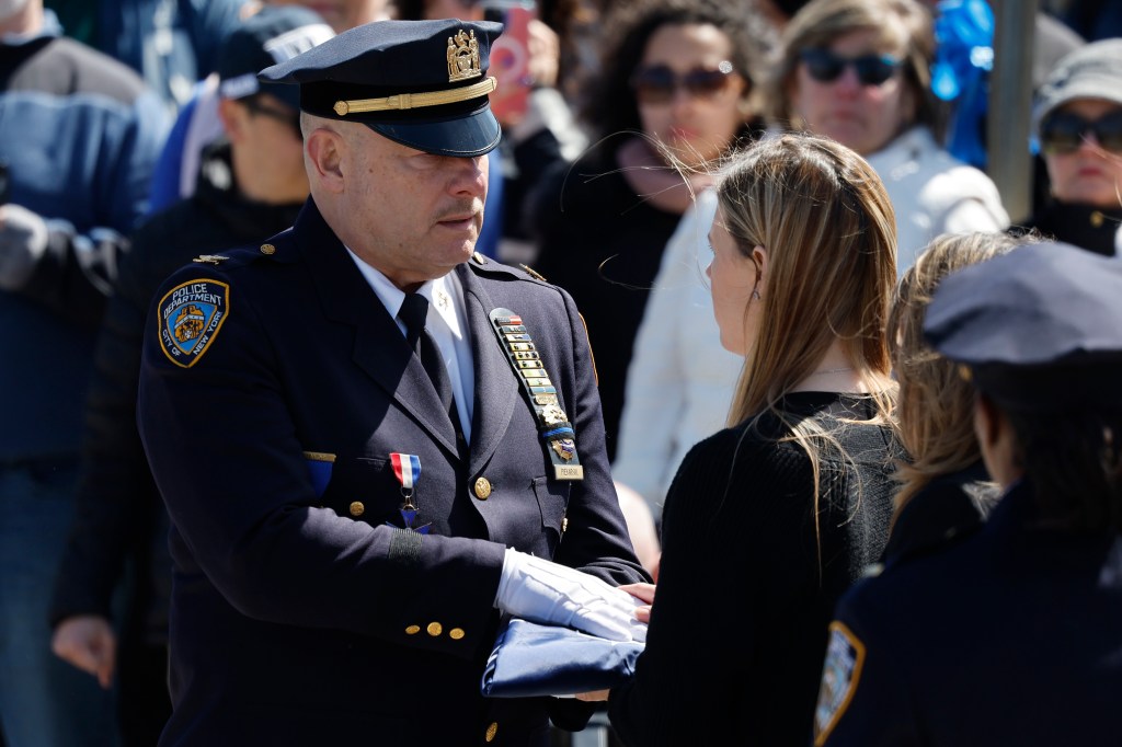 Gut-wrenching photos show Jonathan Diller’s 1-year-old son reaching out from behind fallen NYPD detective’s casket