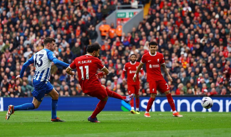Soccer-Liverpool go top after 2-1 comeback win over Brighton