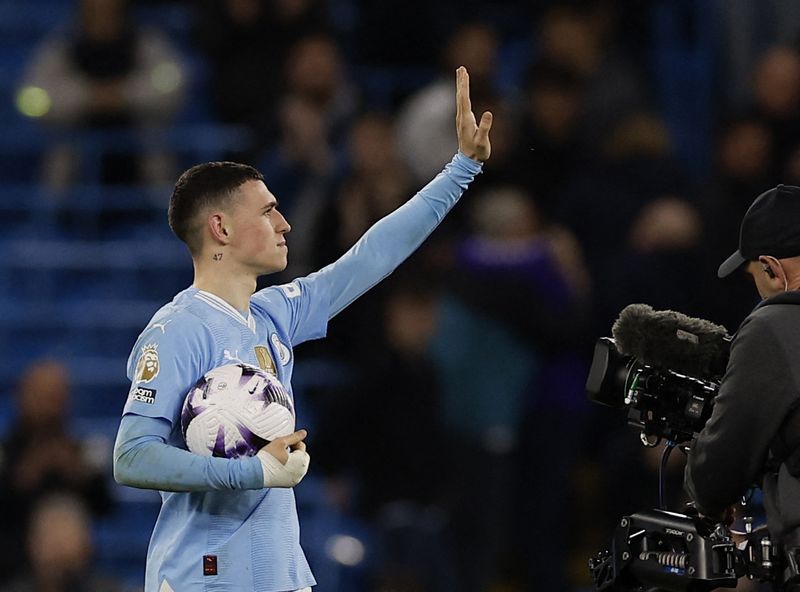 Soccer-Foden hat-trick keeps Man City in thick of title race