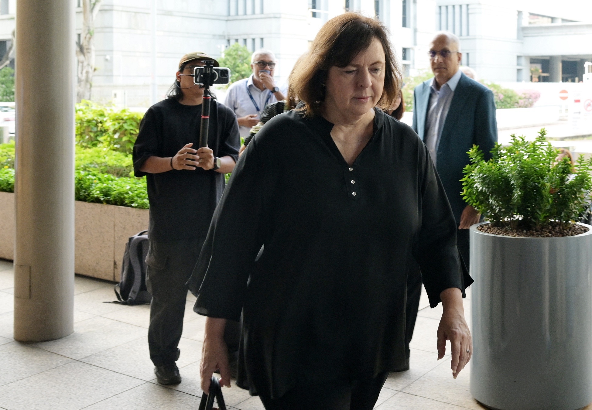 Iswaran’s wife, a prosecution witness, in public gallery a sign there would be no trial