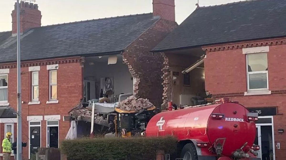 Tractor ploughs into houses tearing off front walls as A51 forced to close