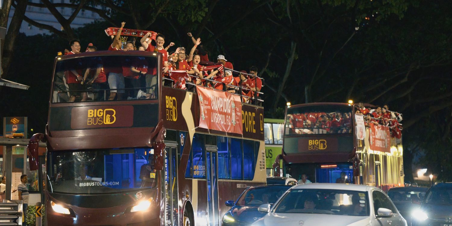 Liverpool fc supporters in s’pore celebrate premier league victory with open-top bus parade in town