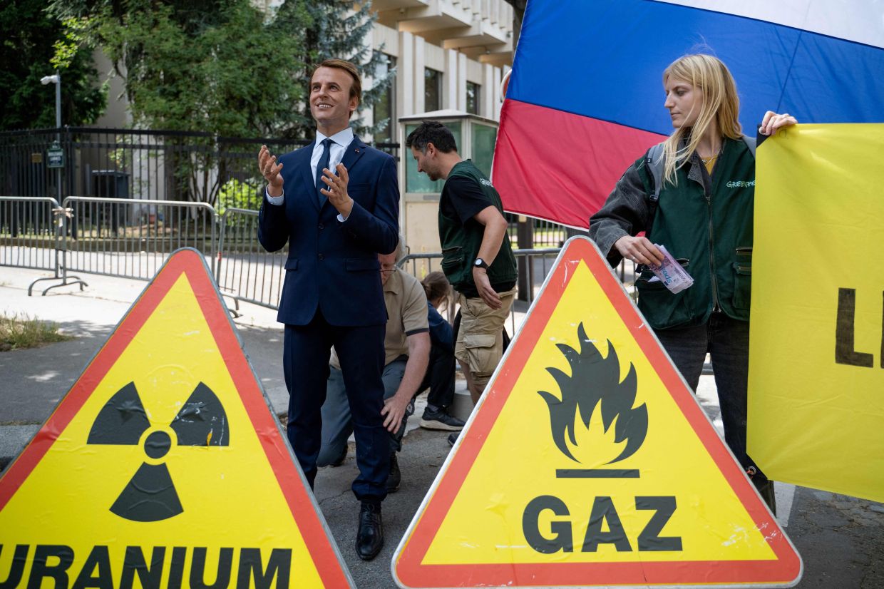 Greenpeace steals Macron wax figure for anti-Moscow protest